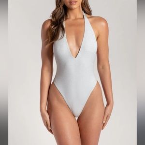 Meshki high waisted backless one piece in silver.